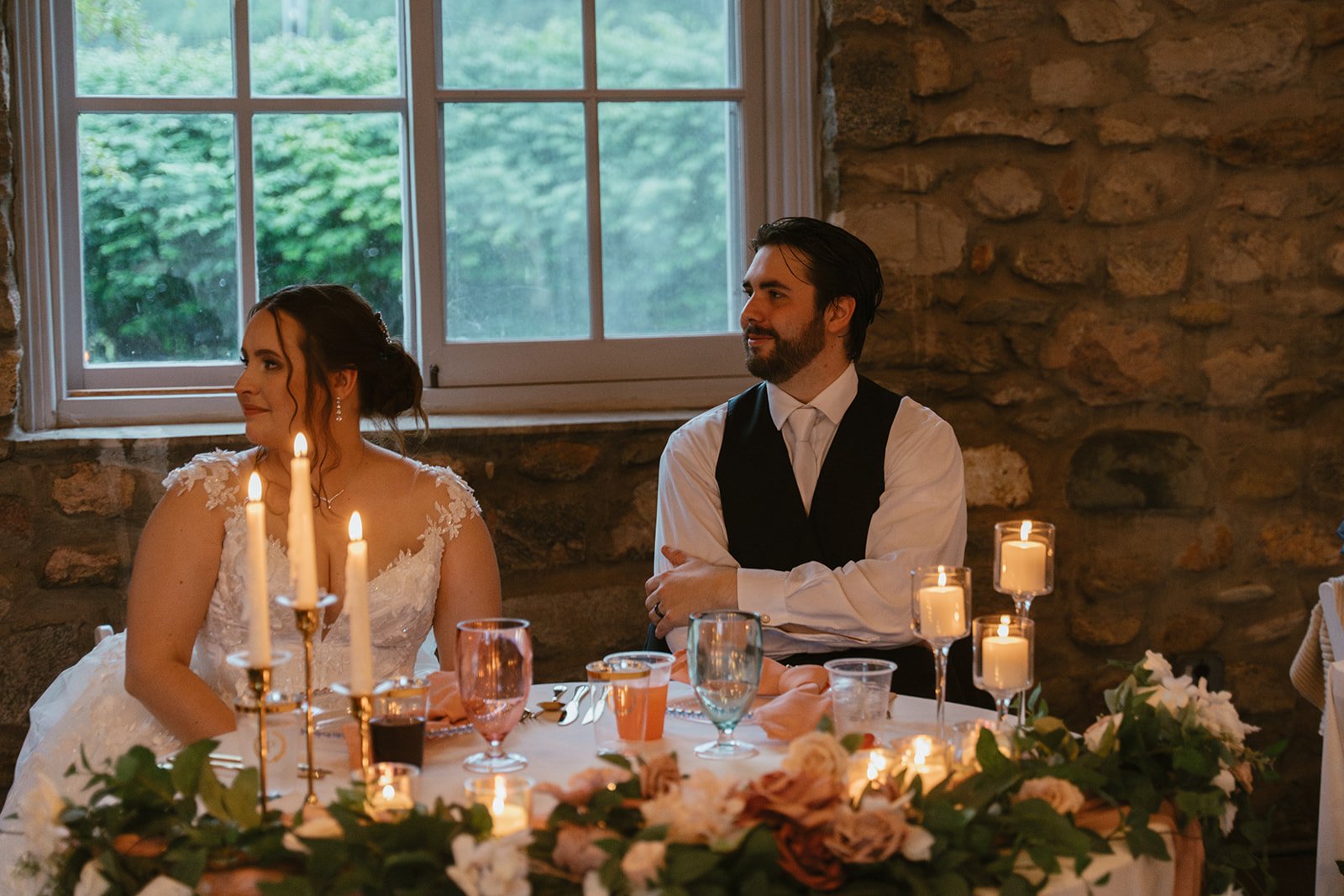 Guests dining at a candle-lit table during the reception