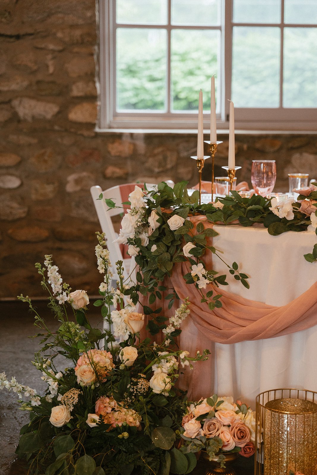 Head table close view with florals and taper candles